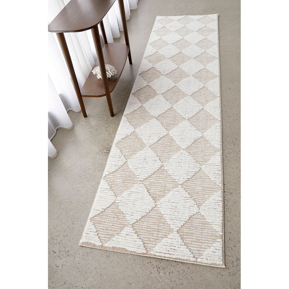 Patterned rug on a concrete floor with a wooden side table.