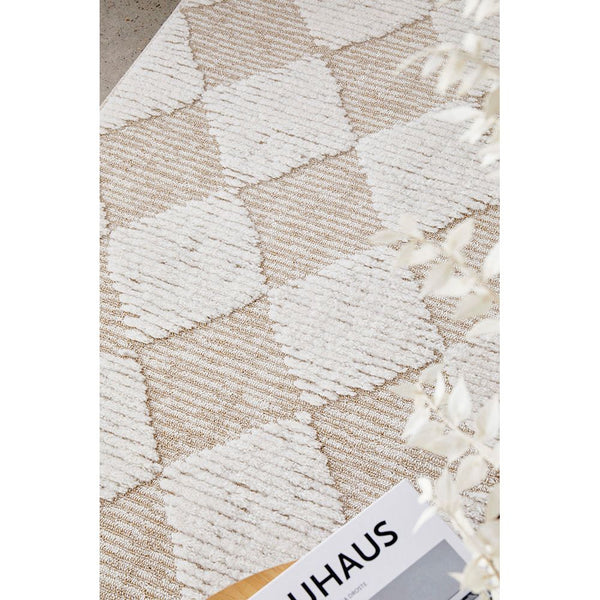 Natural beige and white patterned runner rug with textured diamond shapes and fringed edges.