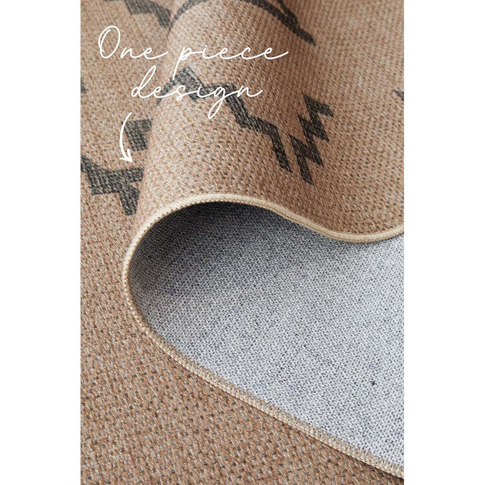 Close-up of a textured rug with a geometric pattern.