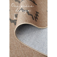 Close-up of a textured rug with a geometric pattern.