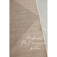 Textured brown rug with robust flatweave pile text on a concrete floor.