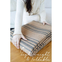 Textured brown and beige machine washable rug pictured folded