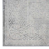 Grey rectangular rug with intricate raised geometric and floral patterns in a modern abstract design.