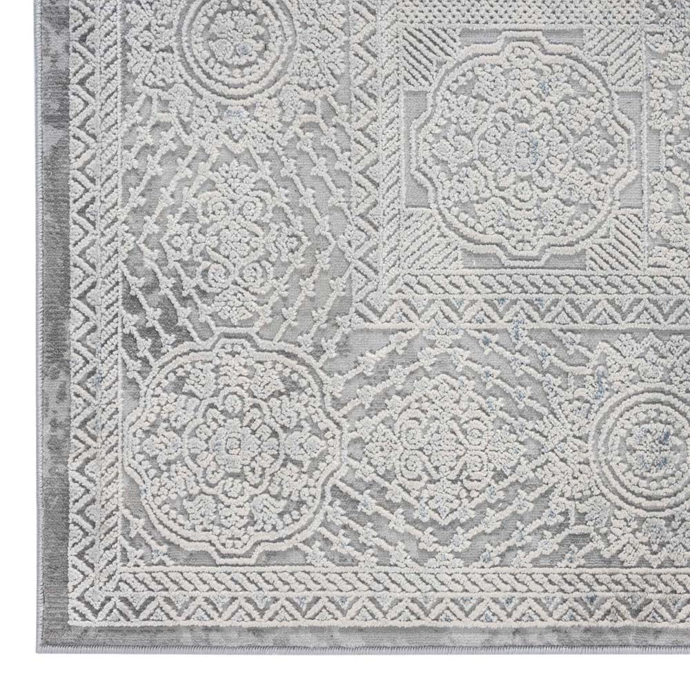 Grey rectangular rug with intricate raised geometric and floral patterns in a modern abstract design.