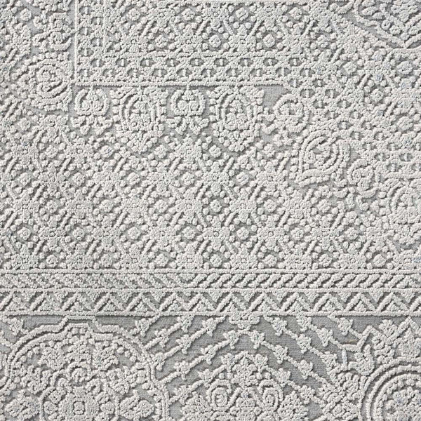 Grey modern rug with intricate textured geometric and floral patterns in a subtle abstract design.