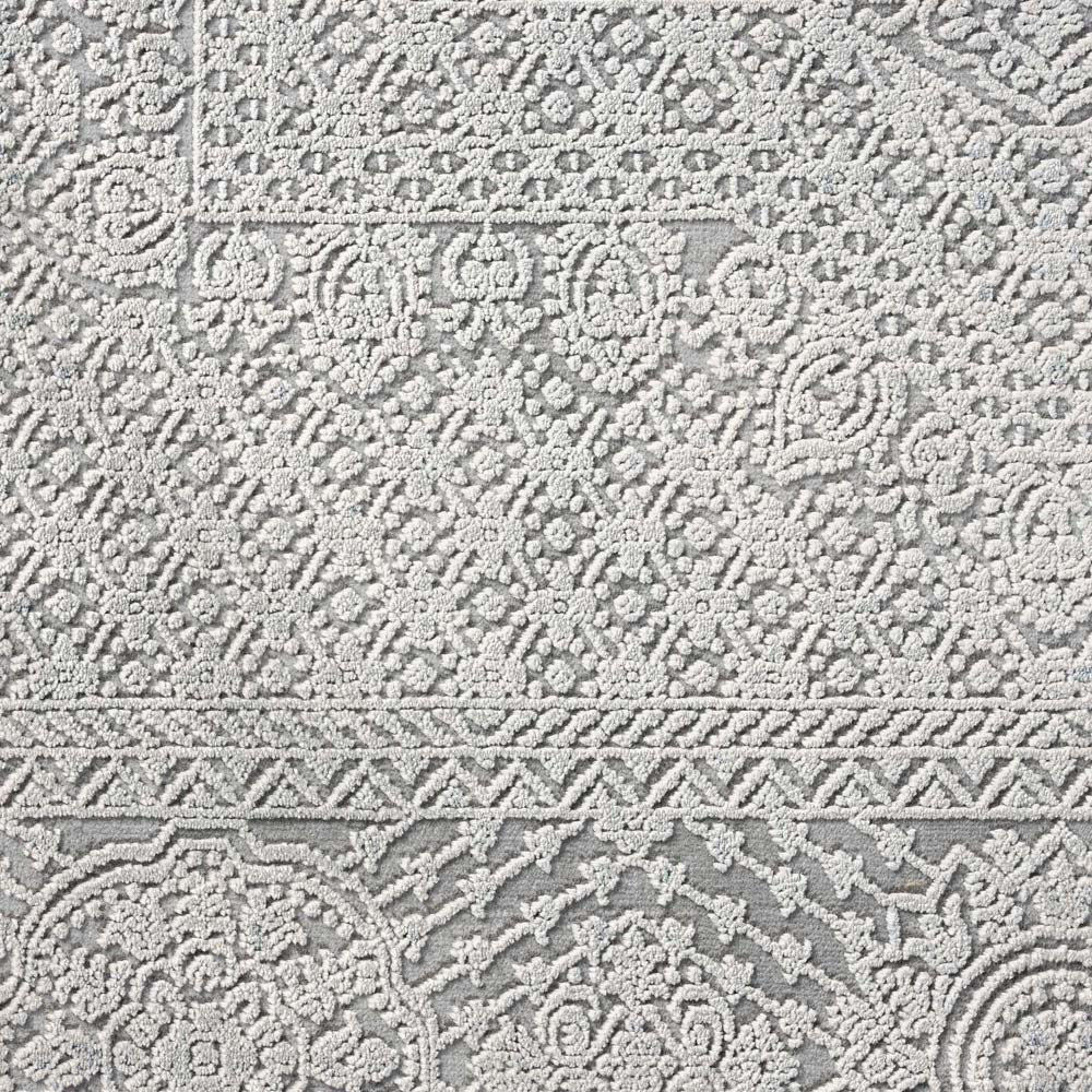 Grey modern rug with intricate textured geometric and floral patterns in a subtle abstract design.