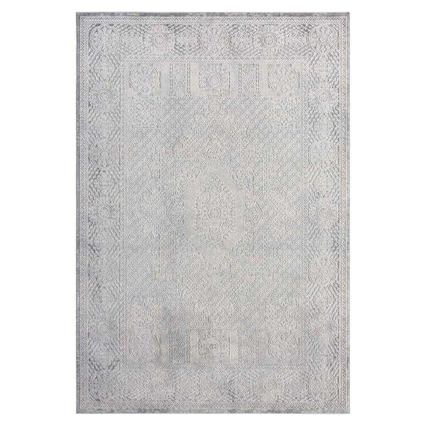 Grey rug with subtle abstract geometric pattern and a slightly distressed look.