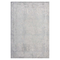Grey rug with subtle abstract geometric pattern and a slightly distressed look.