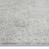 Grey rug with subtle multi-coloured abstract swirling patterns and a soft textured surface.