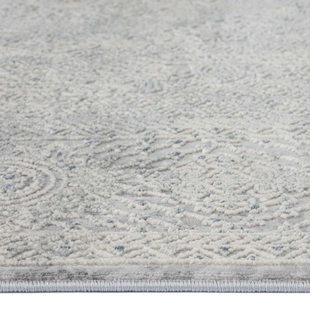 Grey rug with subtle multi-coloured abstract swirling patterns and a soft textured surface.