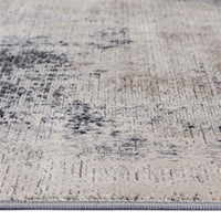 Grey and beige abstract modern runner rug with textured multi-colored pattern and low pile.