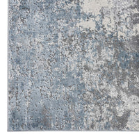 Grey and blue abstract modern rug with textured multi-coloured pattern.