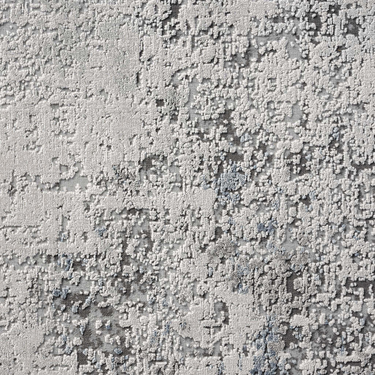 Grey multi-colored abstract modern rug with textured geometric pattern and subtle blue accents.