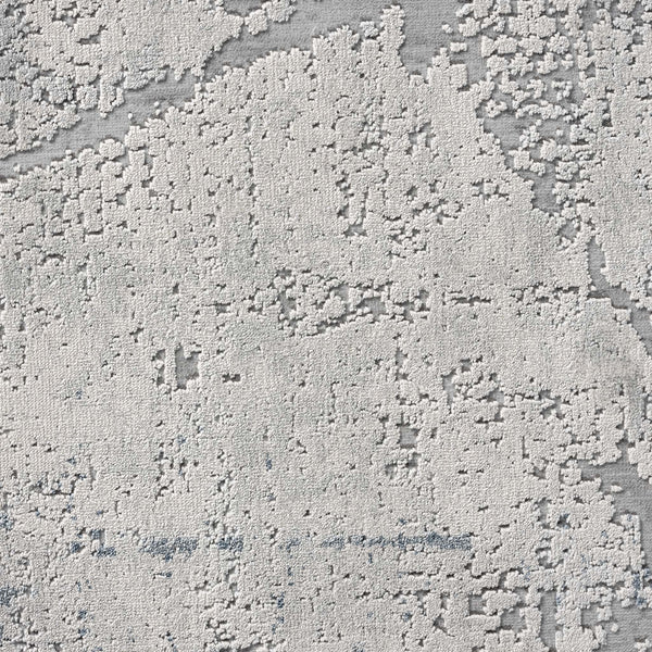 Blue grey abstract modern rug with textured pixelated pattern and subtle geometric accents.