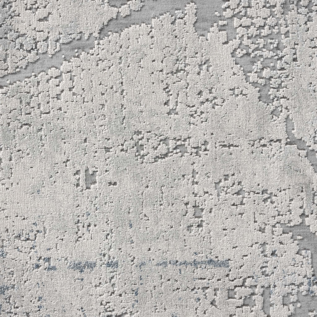 Blue grey abstract modern rug with textured pixelated pattern and subtle geometric accents.