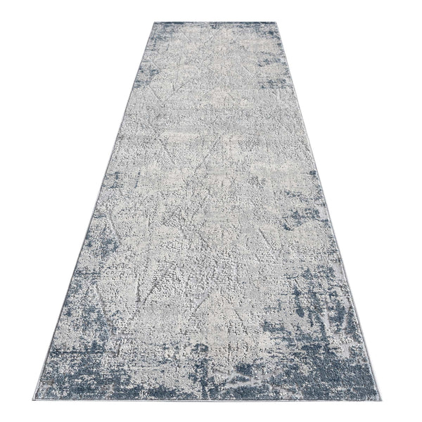 Blue grey abstract modern runner rug with textured multi-colored pattern and distressed edges.