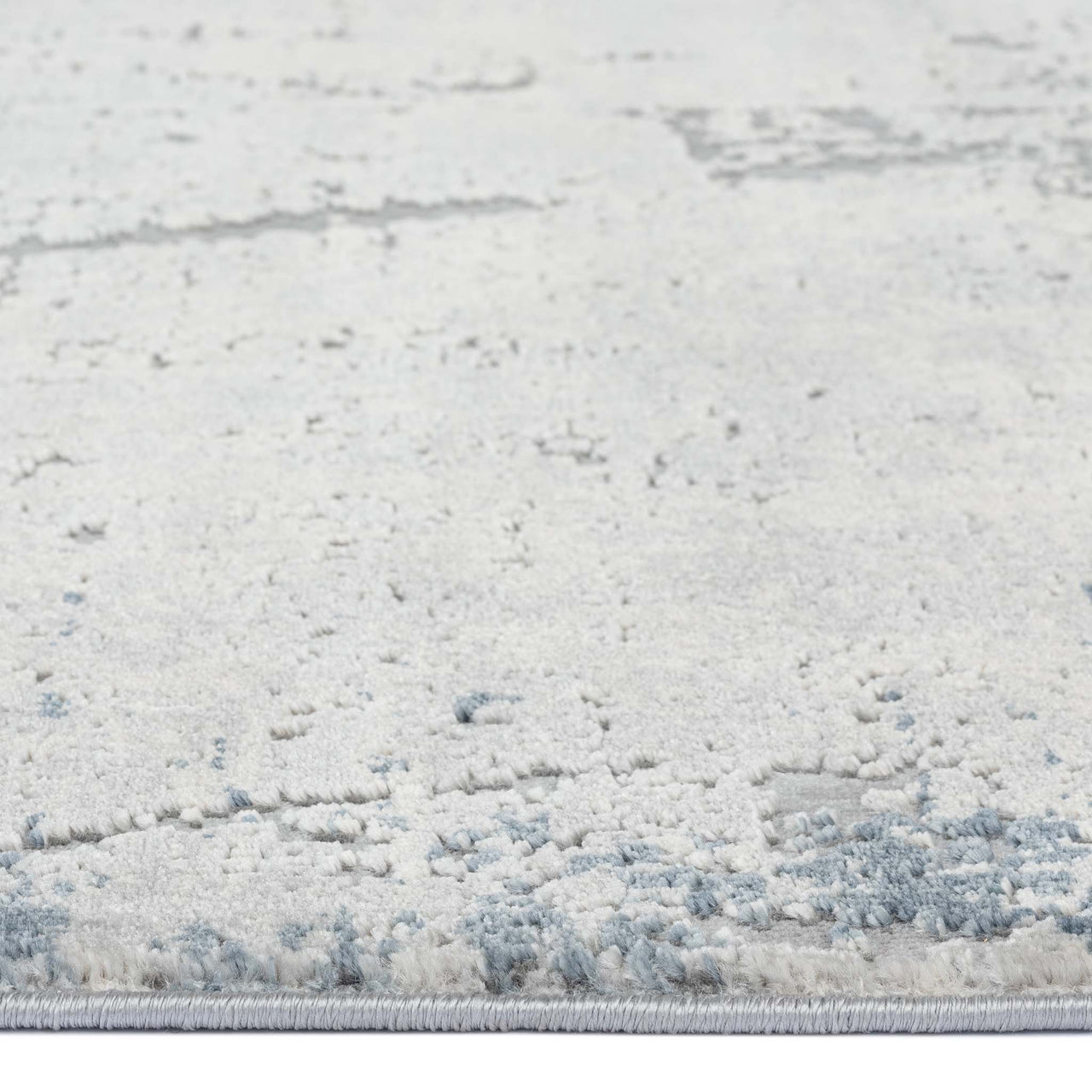 Blue grey abstract modern runner rug with textured, subtle multi-colored pattern and low pile fibers.