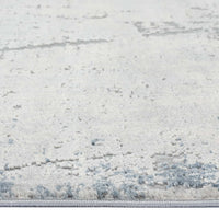 Blue grey abstract modern runner rug with textured, subtle multi-colored pattern and low pile fibers.