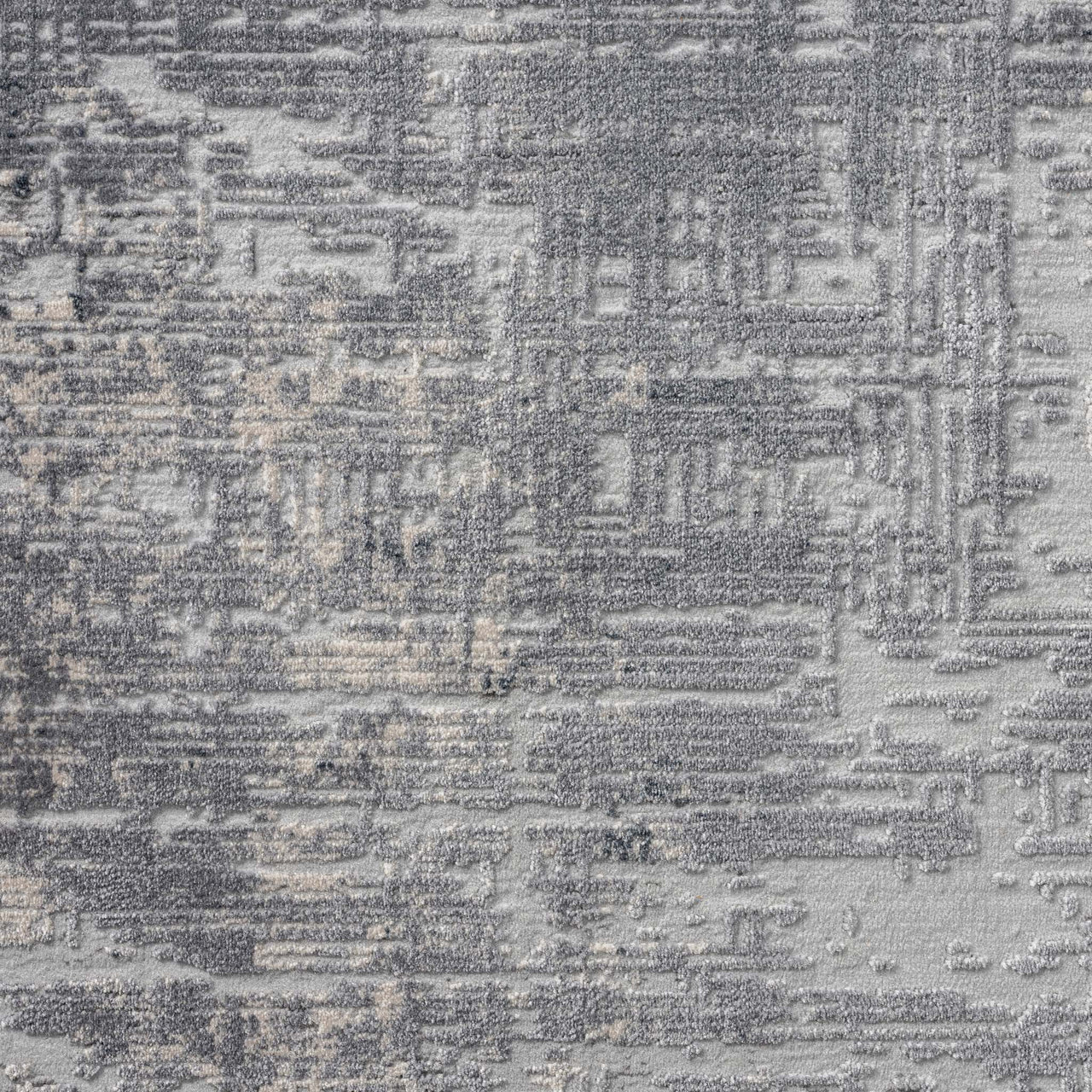 Grey and beige abstract modern rug with textured multi-colored woven pattern.