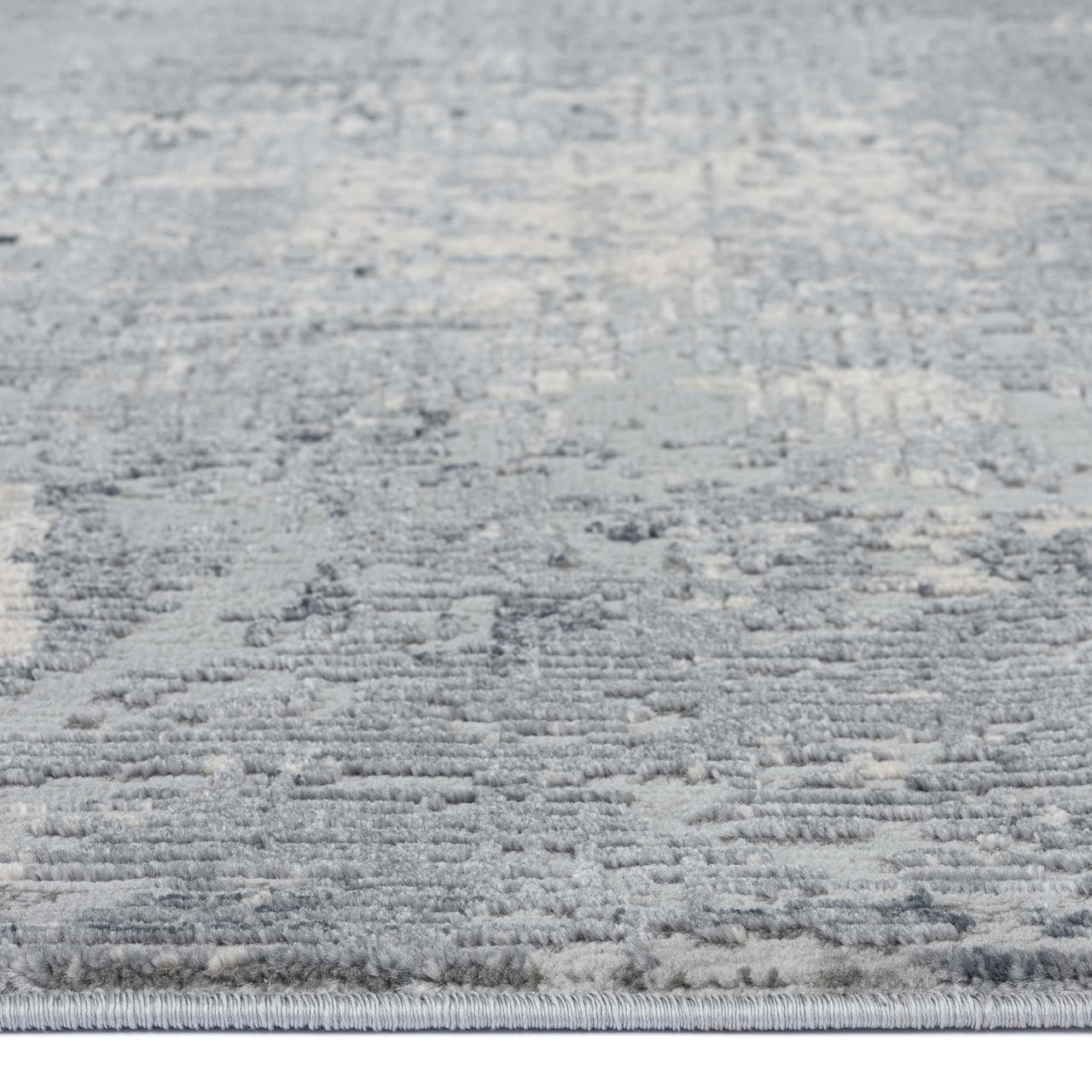 Grey runner rug with abstract multi-colored pattern and low-shedding texture.