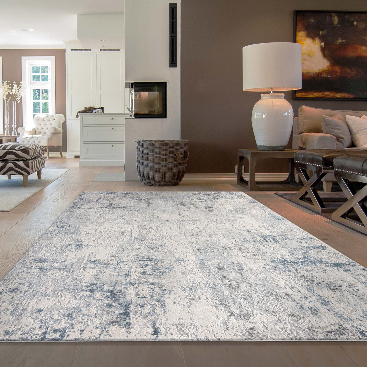 Grey and white abstract modern rug with subtle distressed texture in living room setting.