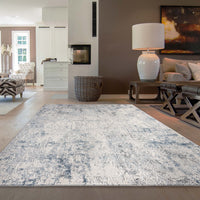 Grey and white abstract modern rug with subtle distressed texture in living room setting.