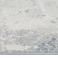 Grey abstract modern rug with subtle blue and white textured patterns, low pile surface.