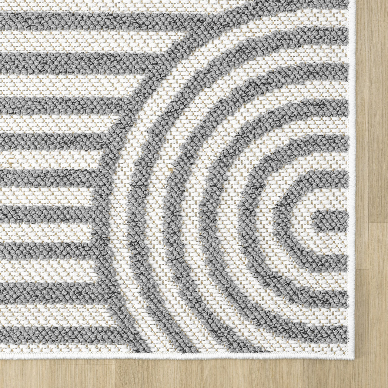 Grey and white flatweave runner rug with concentric circle and stripe geometric pattern.