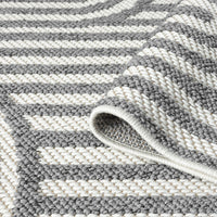 Grey and white flatweave runner rug with bold geometric striped pattern and textured weave.