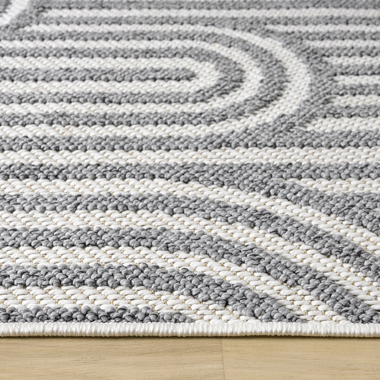 Grey flatweave runner rug with textured geometric arches and a minimalist design.