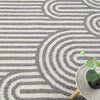 Grey flatweave rug with concentric arches and horizontal stripe geometric pattern.