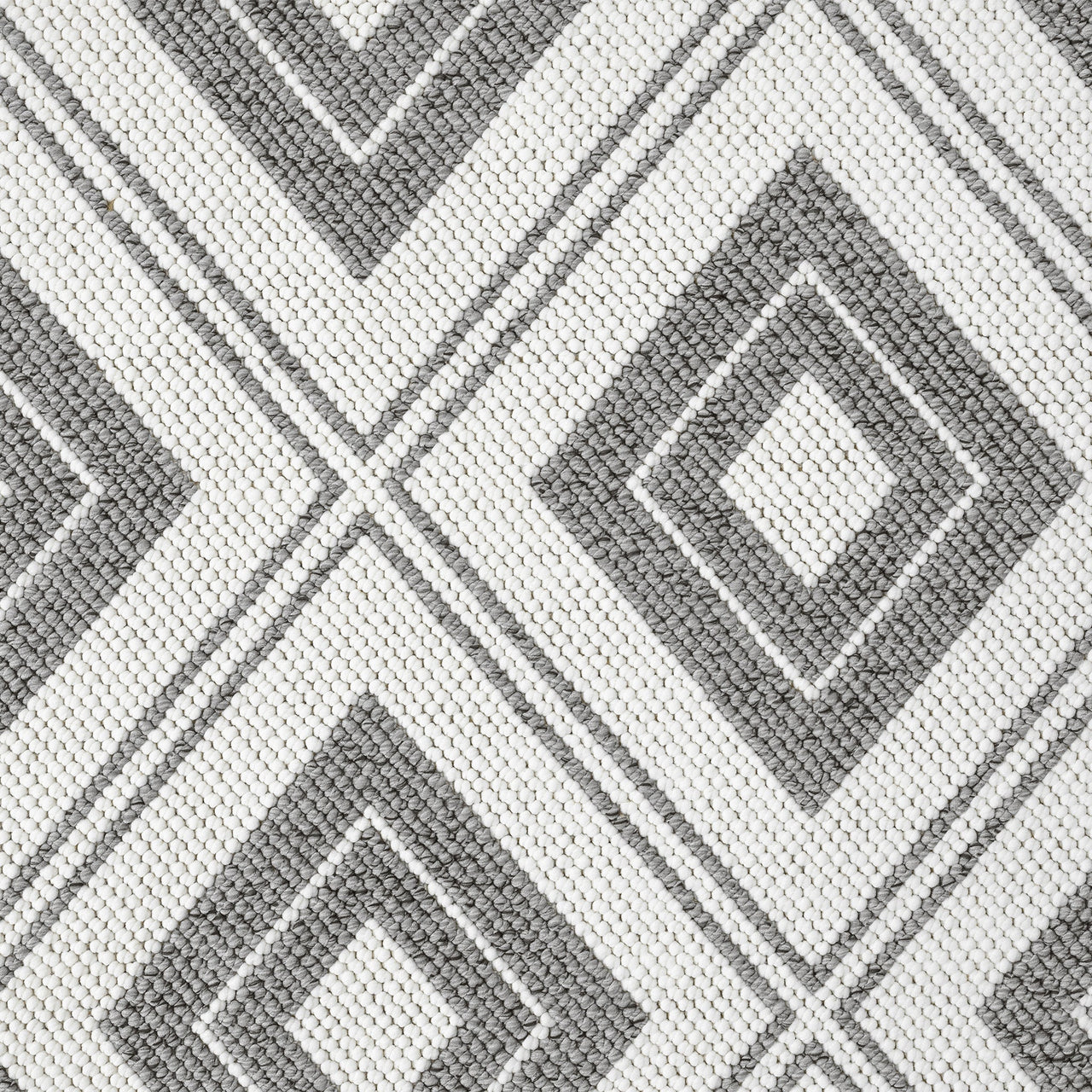 Grey and white flatweave rug with diamond geometric pattern and textured weave.