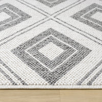 Grey and white flatweave runner rug with geometric square pattern and textured weave on hardwood floor.