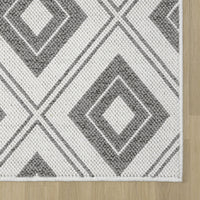 Grey and white flatweave rug with large diamond geometric pattern and clean edges.