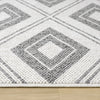 Grey flatweave rug with geometric diamond pattern and textured polyester weave.