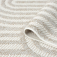 Cream flatweave runner rug with subtle raised geometric arch pattern and textured weave.