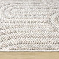 Cream flatweave runner rug with textured geometric patterns on wooden floor.