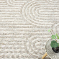 Cream flatweave rug with raised geometric arches pattern and textured stripes.