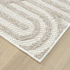 Cream flatweave rug with textured geometric arch pattern and subtle beige accents.