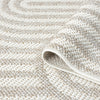Cream flatweave rug with textured arches pattern in a minimalist modern design.
