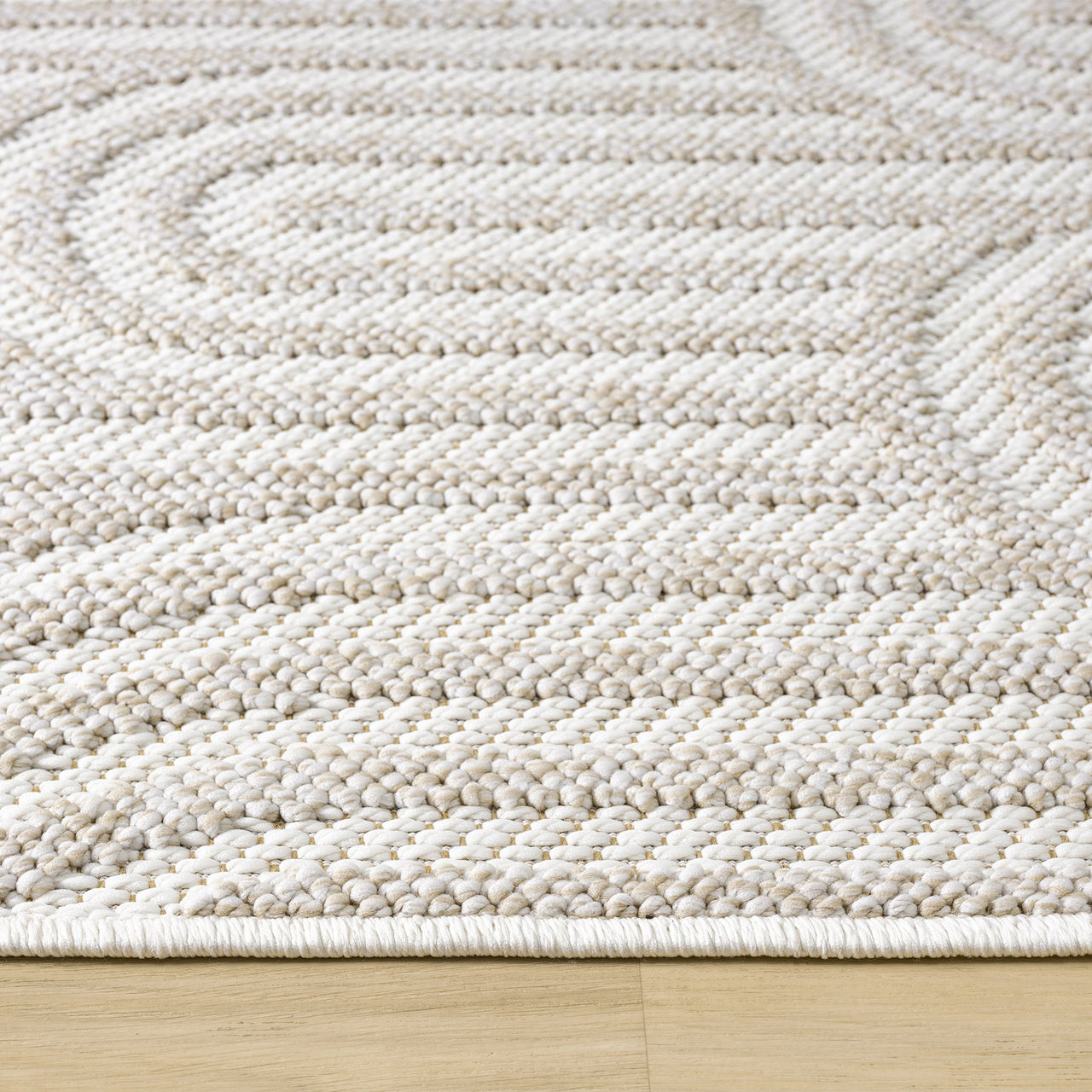 Cream flatweave rug with textured geometric arch patterns and a low-profile design.