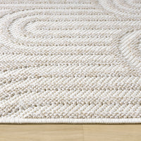 Cream flatweave rug with textured geometric arch patterns and a low-profile design.