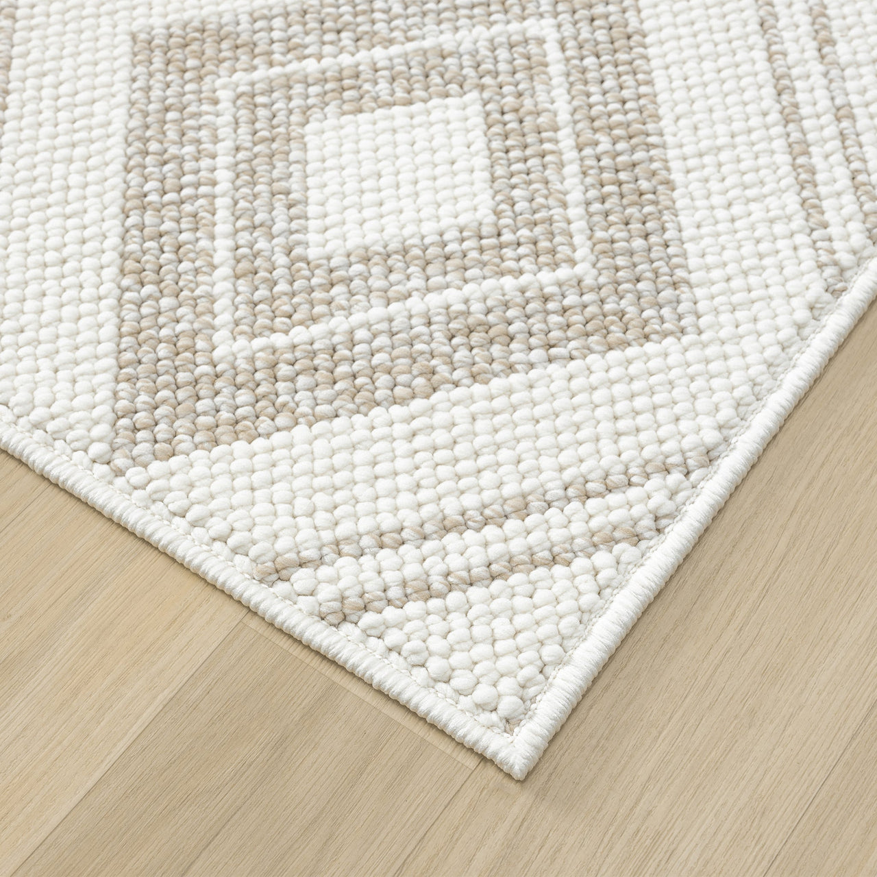 Cream flatweave runner rug with textured geometric square pattern and clean edges on light wood floor.