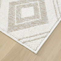 Cream flatweave runner rug with textured geometric square pattern and clean edges on light wood floor.