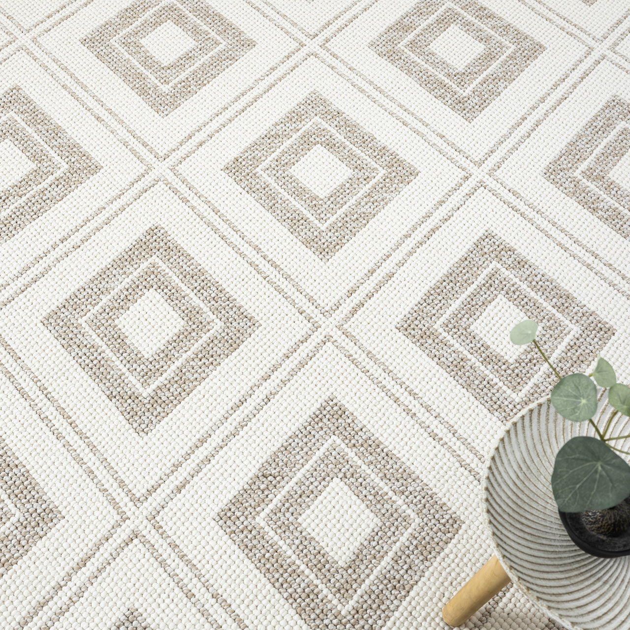 Cream flatweave rug with beige geometric diamond pattern and textured detailing.