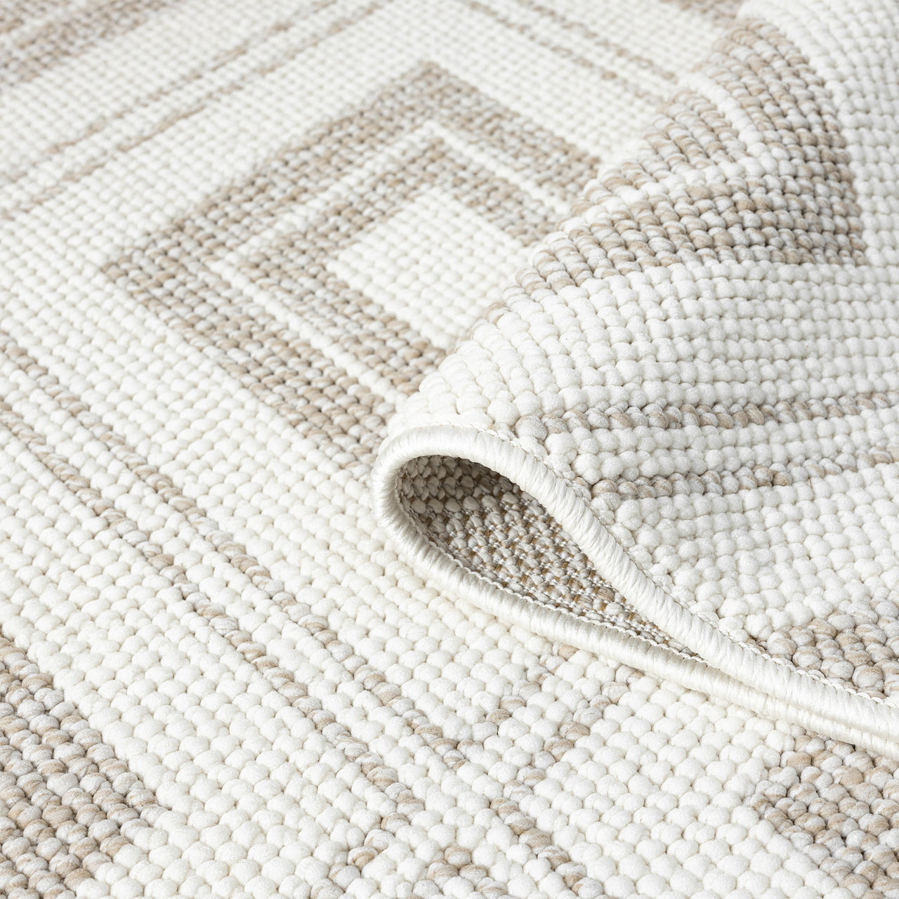 Cream flatweave rug with beige geometric diamond pattern and textured weave detail.