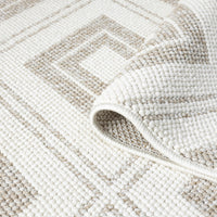 Cream flatweave rug with beige geometric diamond pattern and textured weave detail.