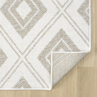 Cream flatweave rug with beige diamond geometric pattern and white border on wooden floor.