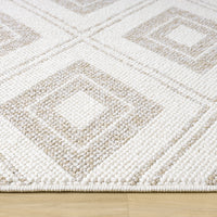 Cream flatweave rug with beige geometric diamond pattern and textured design on hardwood floor.
