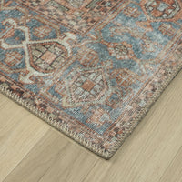 Multicolored traditional runner rug with intricate floral and geometric patterns in muted blue, rust, and beige tones.